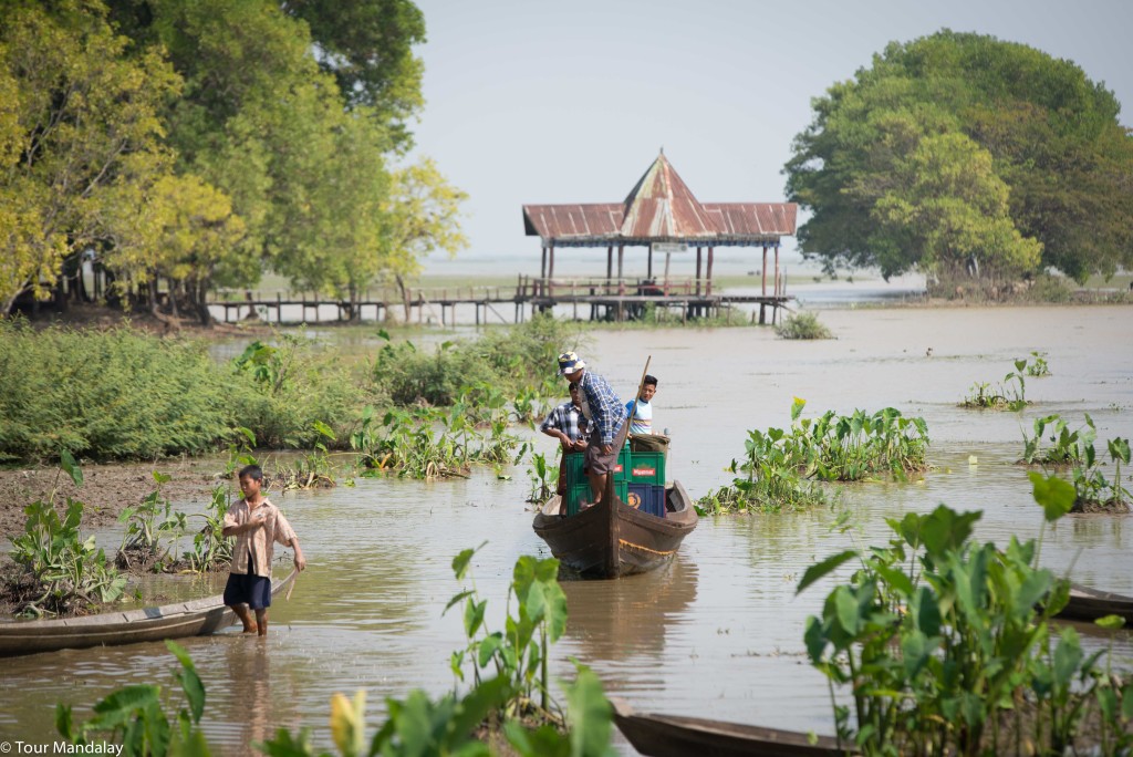 Locals ferry crates of Myanmar Beer to the nearby restaurants