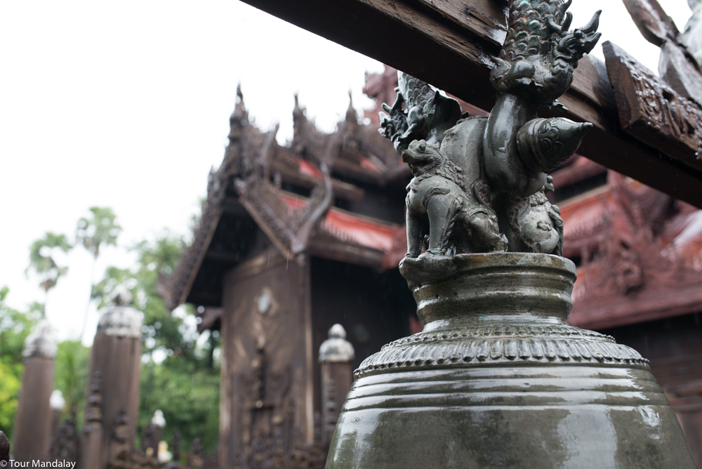 A brass bell hangs in from of Shwe In Bin Kyaung