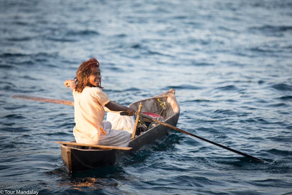 Moken lady rowing boat